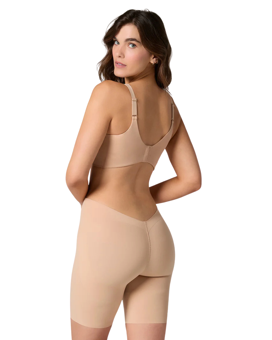 Woman wearing a beige shapewear garment